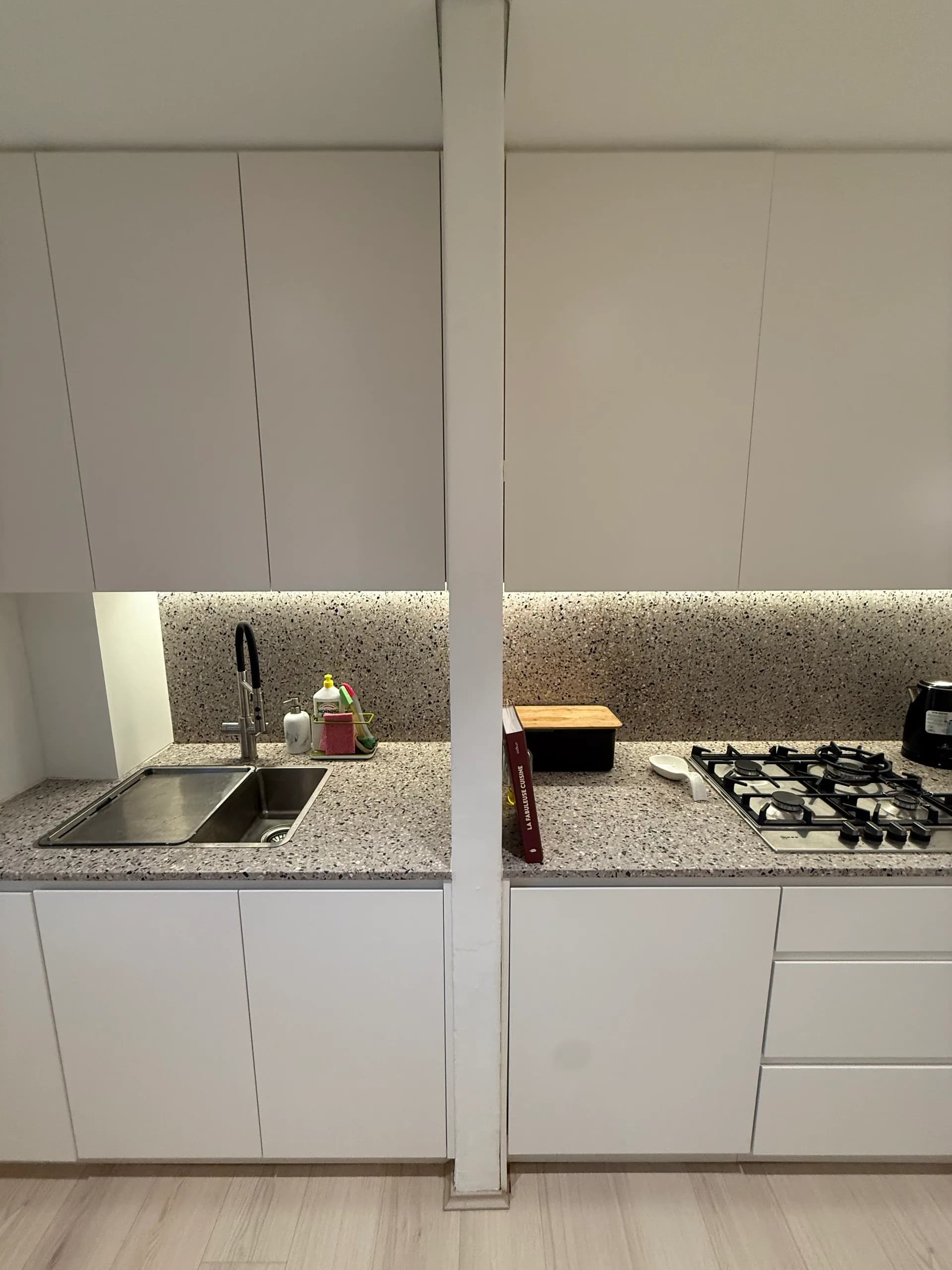 Apartment kitchen renovation with stone benchtop and cooktop
