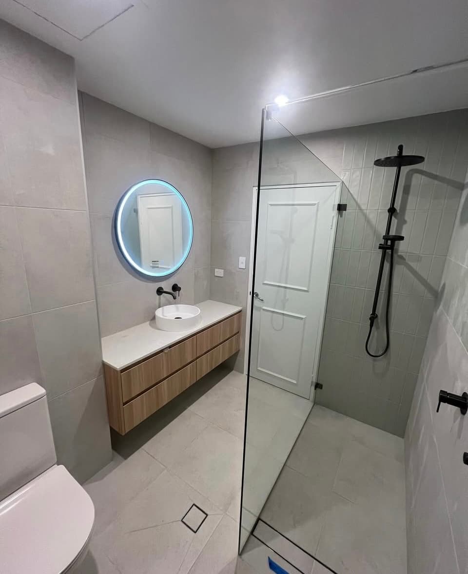 Small bathroom renovation with backlit mirror