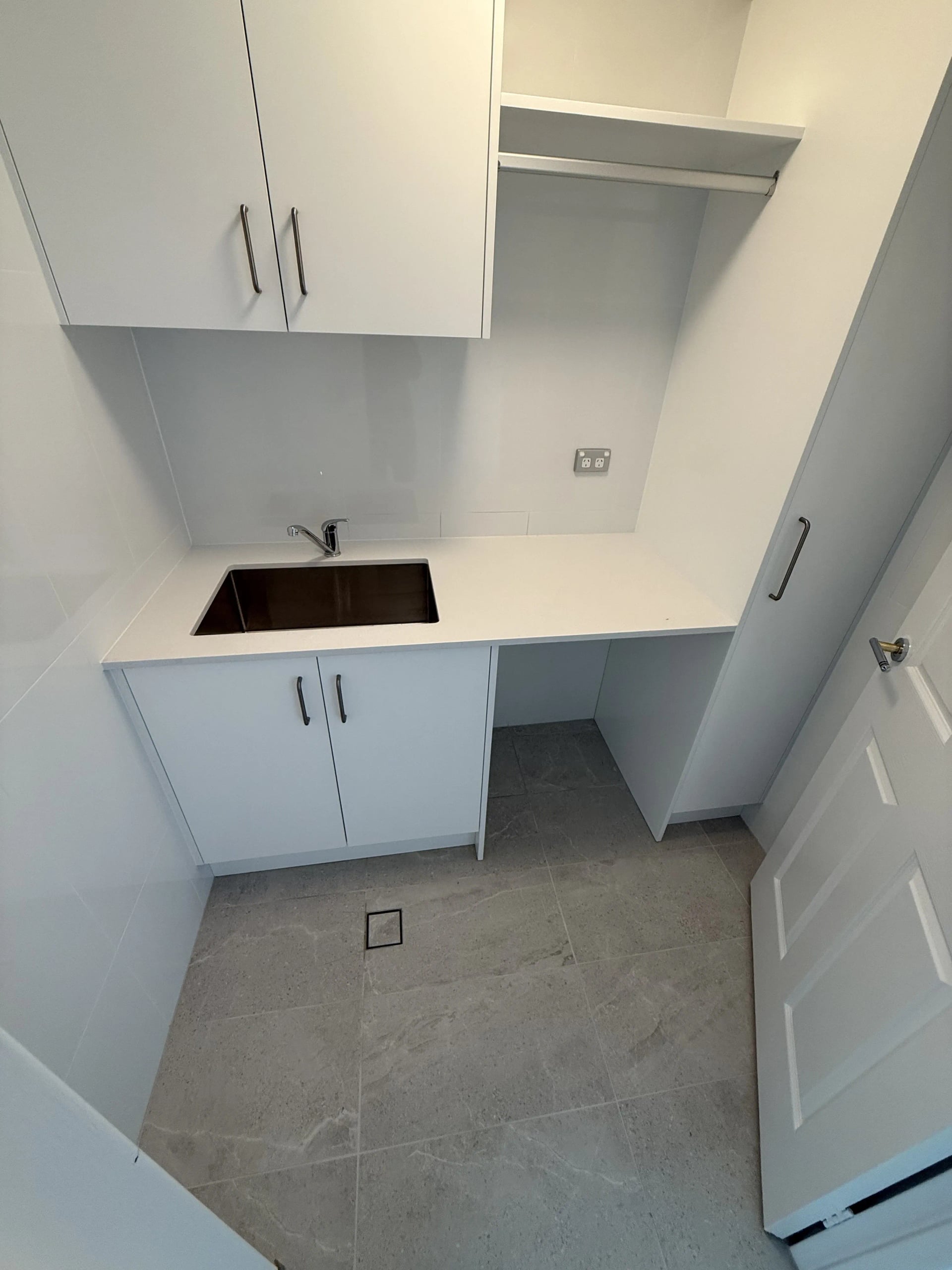 Renovated apartment laundry with stone benchtop in Milsons Point