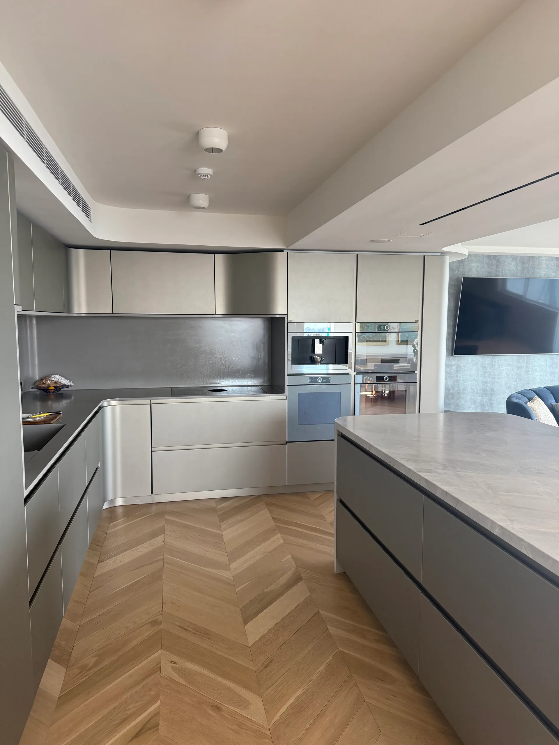 Renovated apartment kitchen with integrated built-in ovens