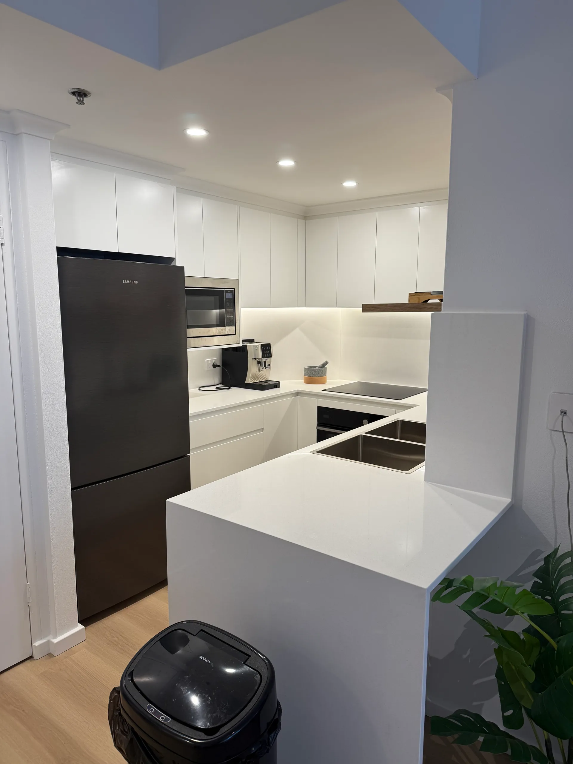 U-shaped kitchen with white cabinetry