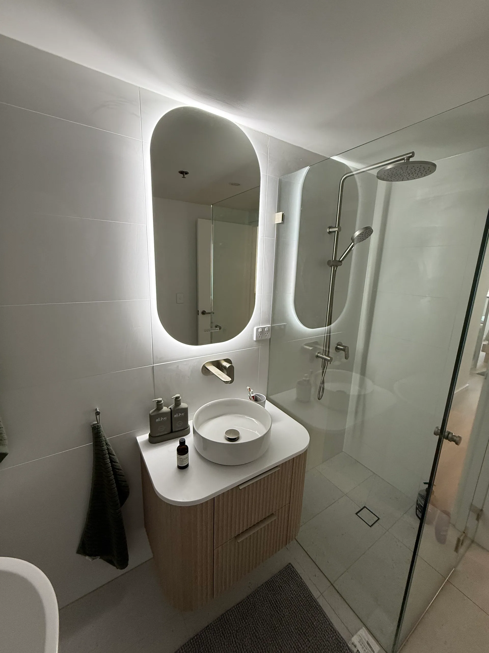 Oval LED mirror above vanity