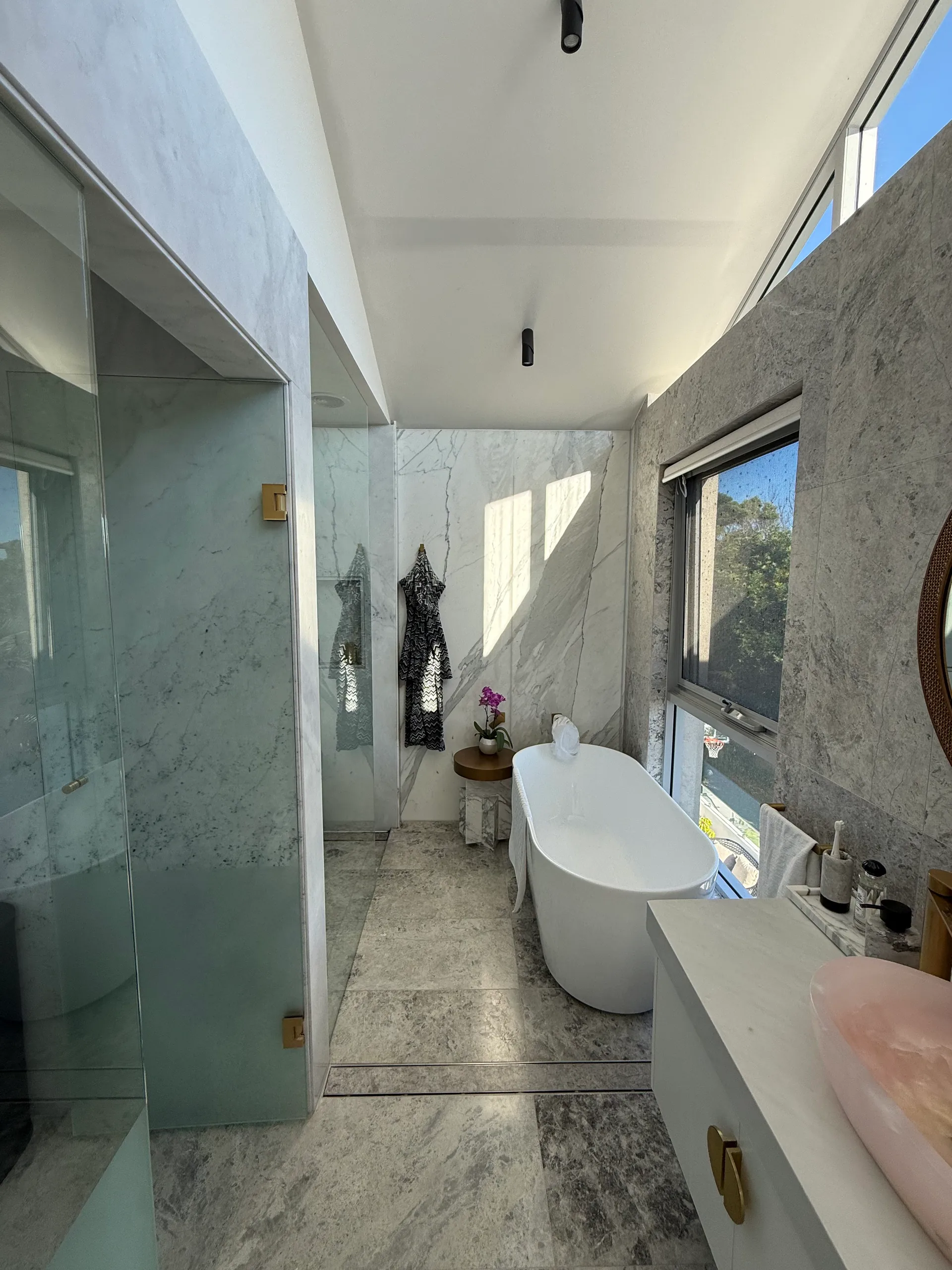 Freestanding bath with marble surround