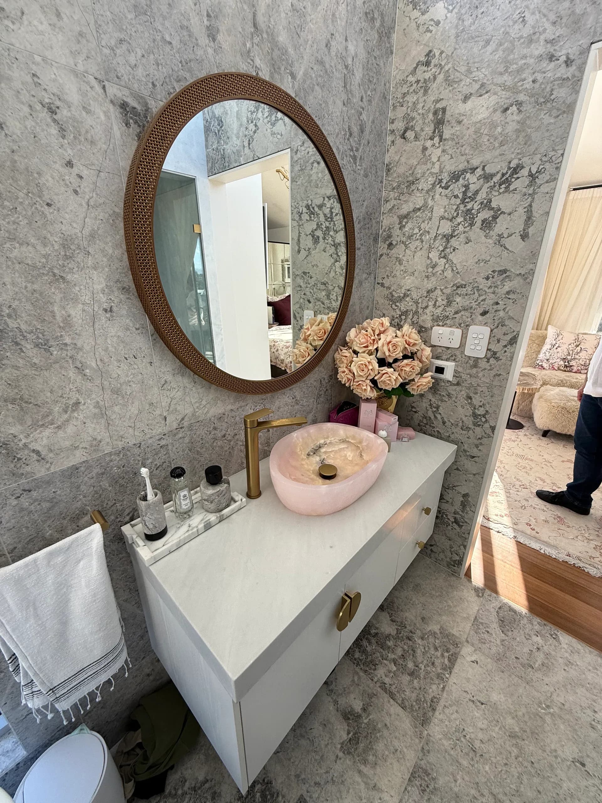 Renovated Vaucluse bathroom vanity in stone with a round mirror above it