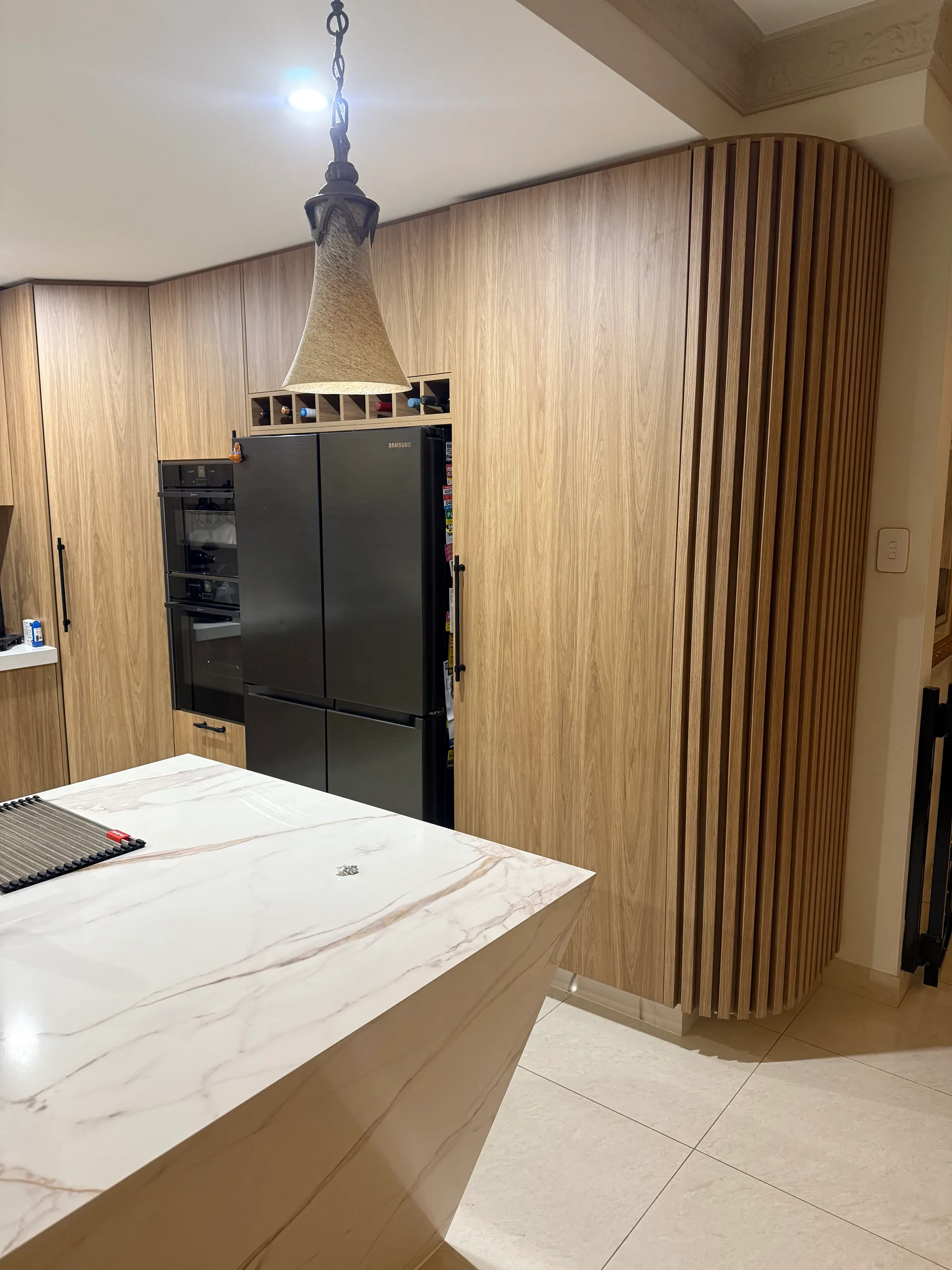 Built-in fridge enclosure with timber cabinetry