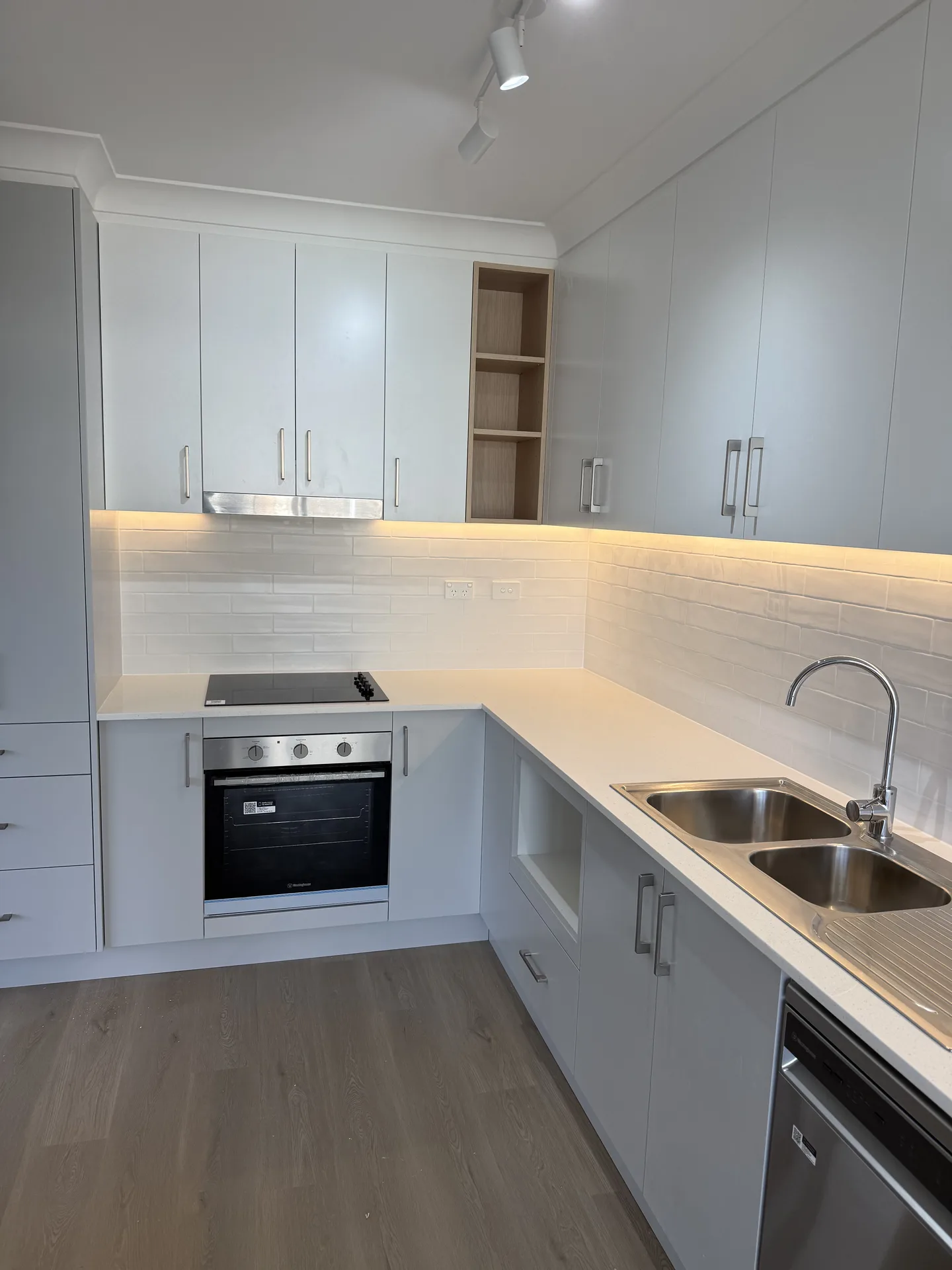 Bench with oven, open appliance cavity and timber-look shelving nook above