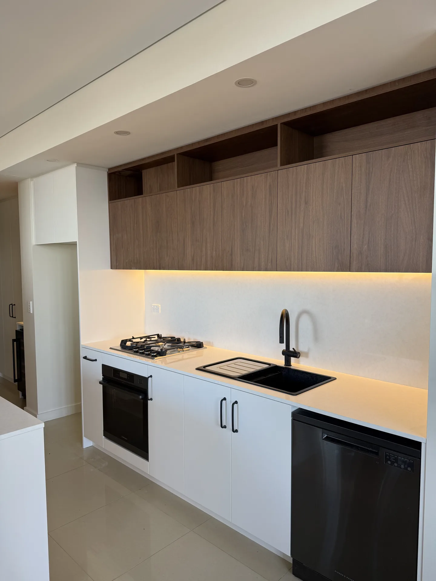 Full length of the kitchen run showing oven, cooktop, sink and dishwasher