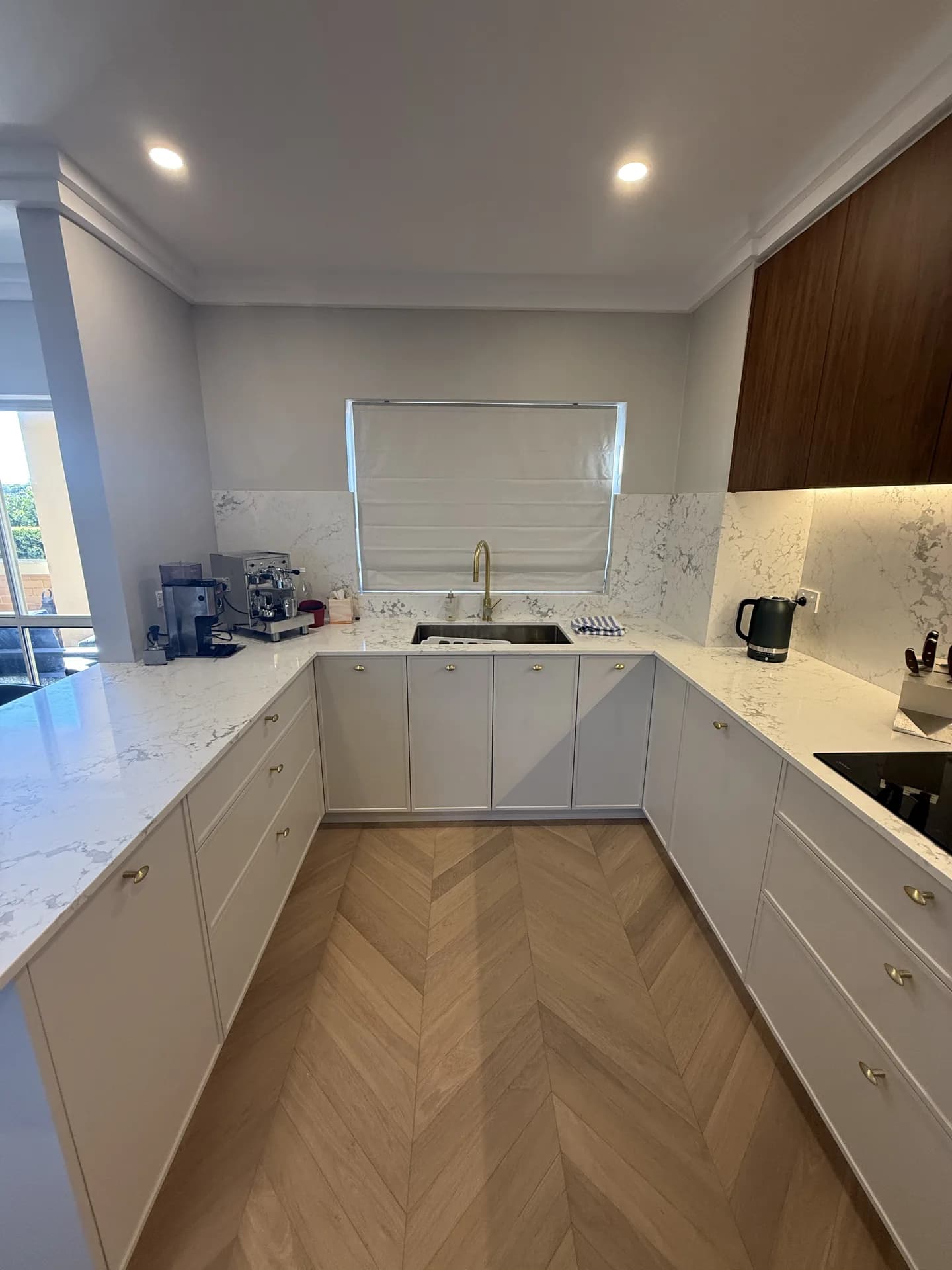 North Sydney kitchen with the sink under the window and a full-height stone splashback
