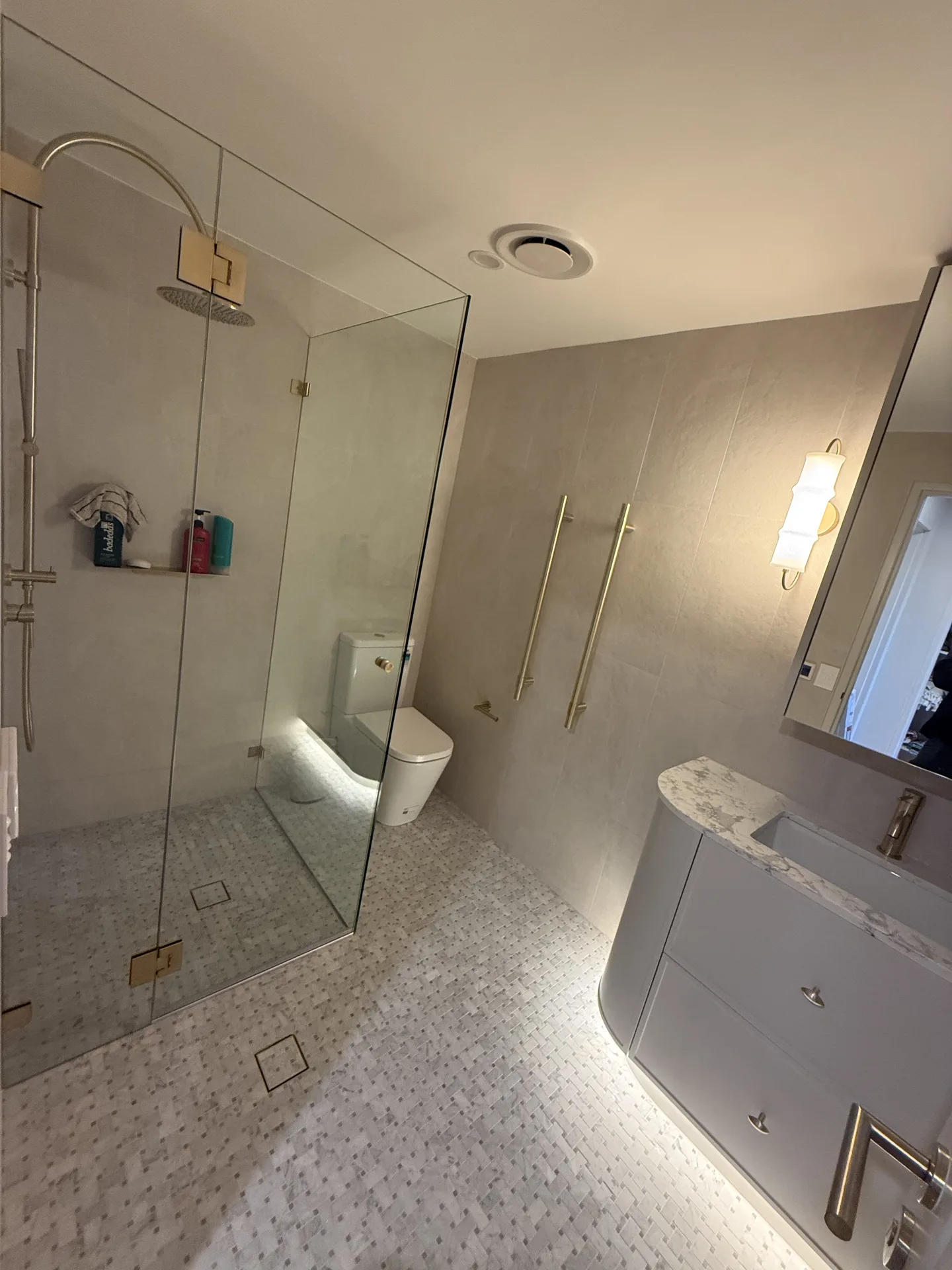 Second bathroom walk-in shower with frameless glass, brass rails and mosaic floor
