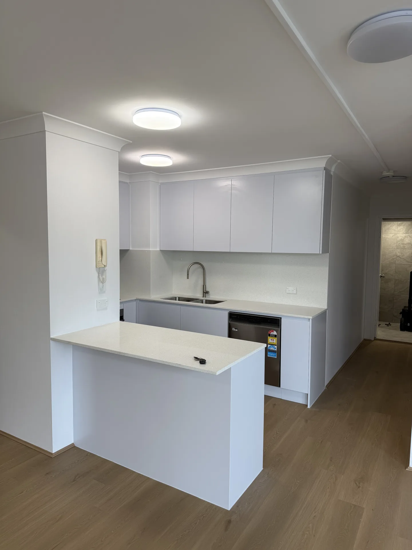 Kitchen and peninsula seen from the open-plan living area