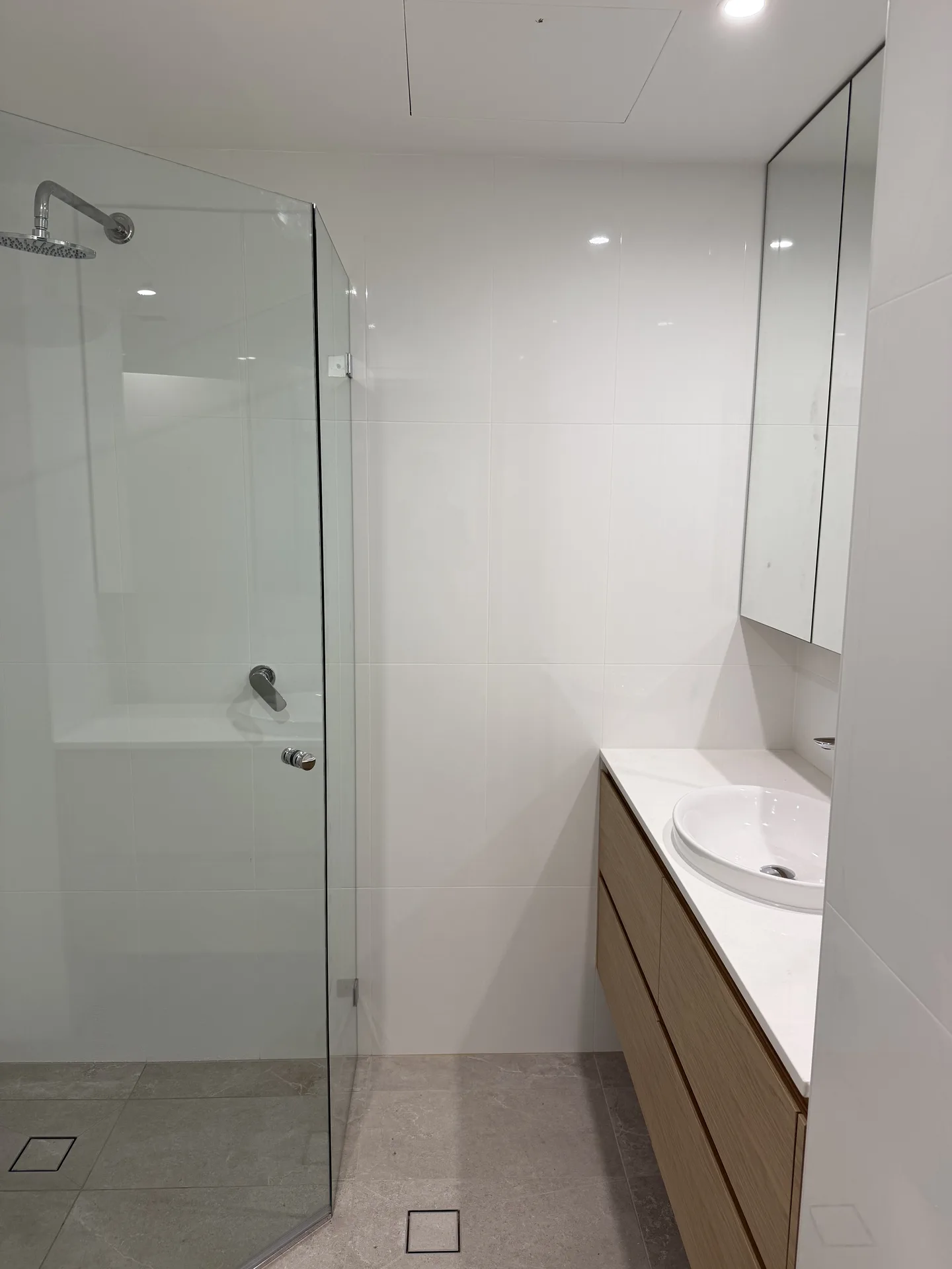 Pyrmont apartment bathroom with frameless glass shower and floating timber vanity