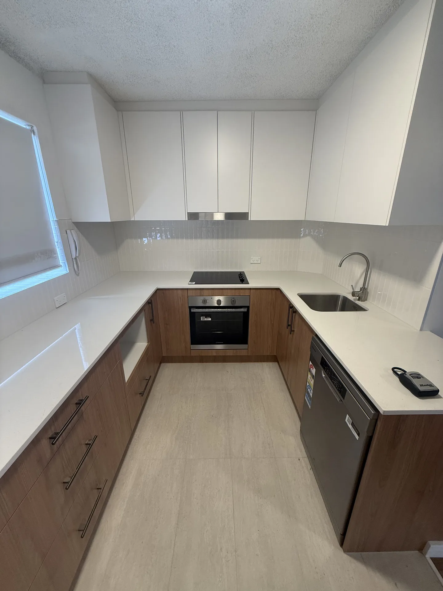 Kitchen U-shape with electric cooktop, under-bench oven, stainless sink and dishwasher