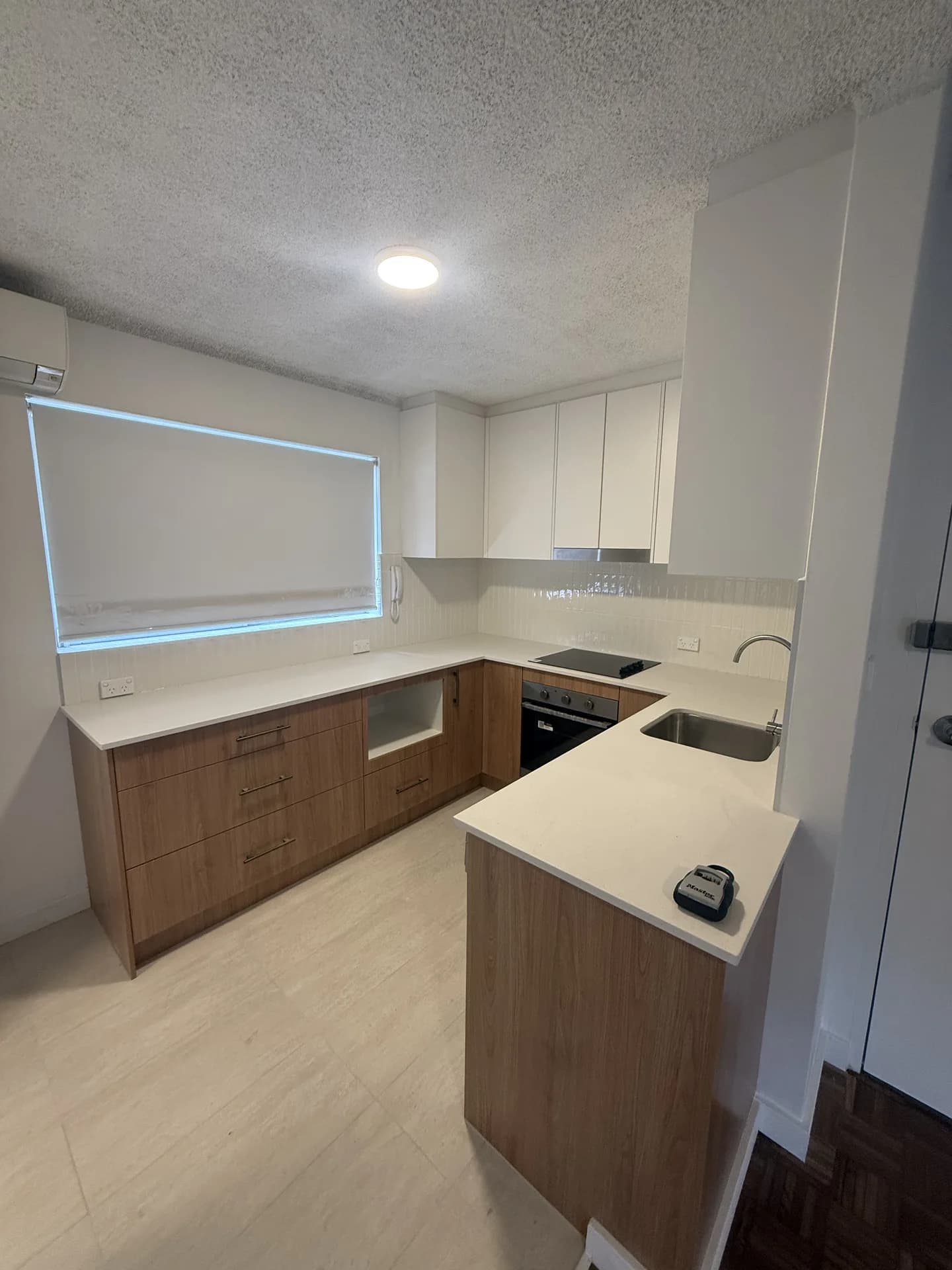 Renovated Randwick kitchen showing the return benchtop and a long window over the bench