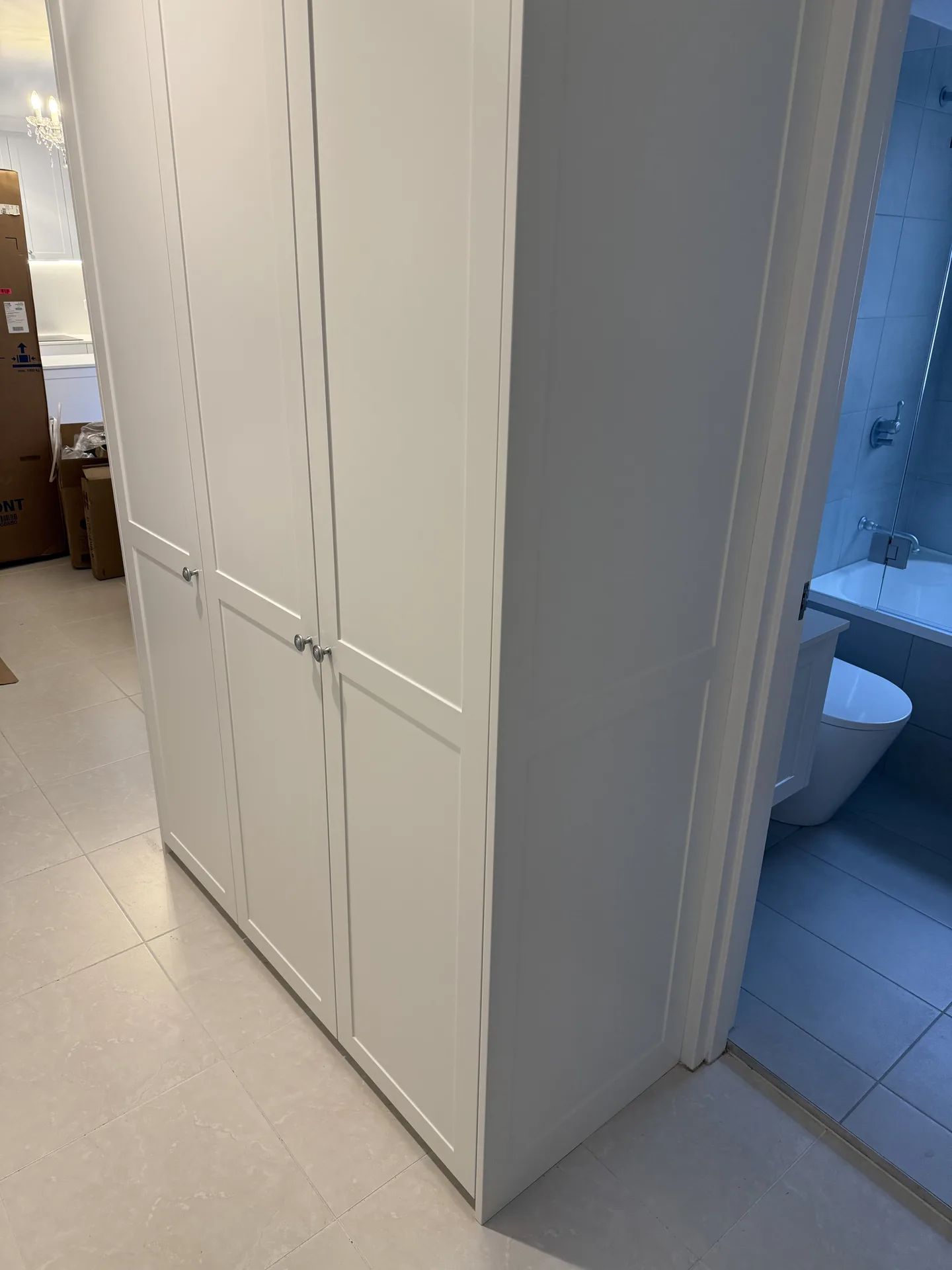Floor-to-ceiling white shaker joinery in the hallway of a renovated Ryde apartment