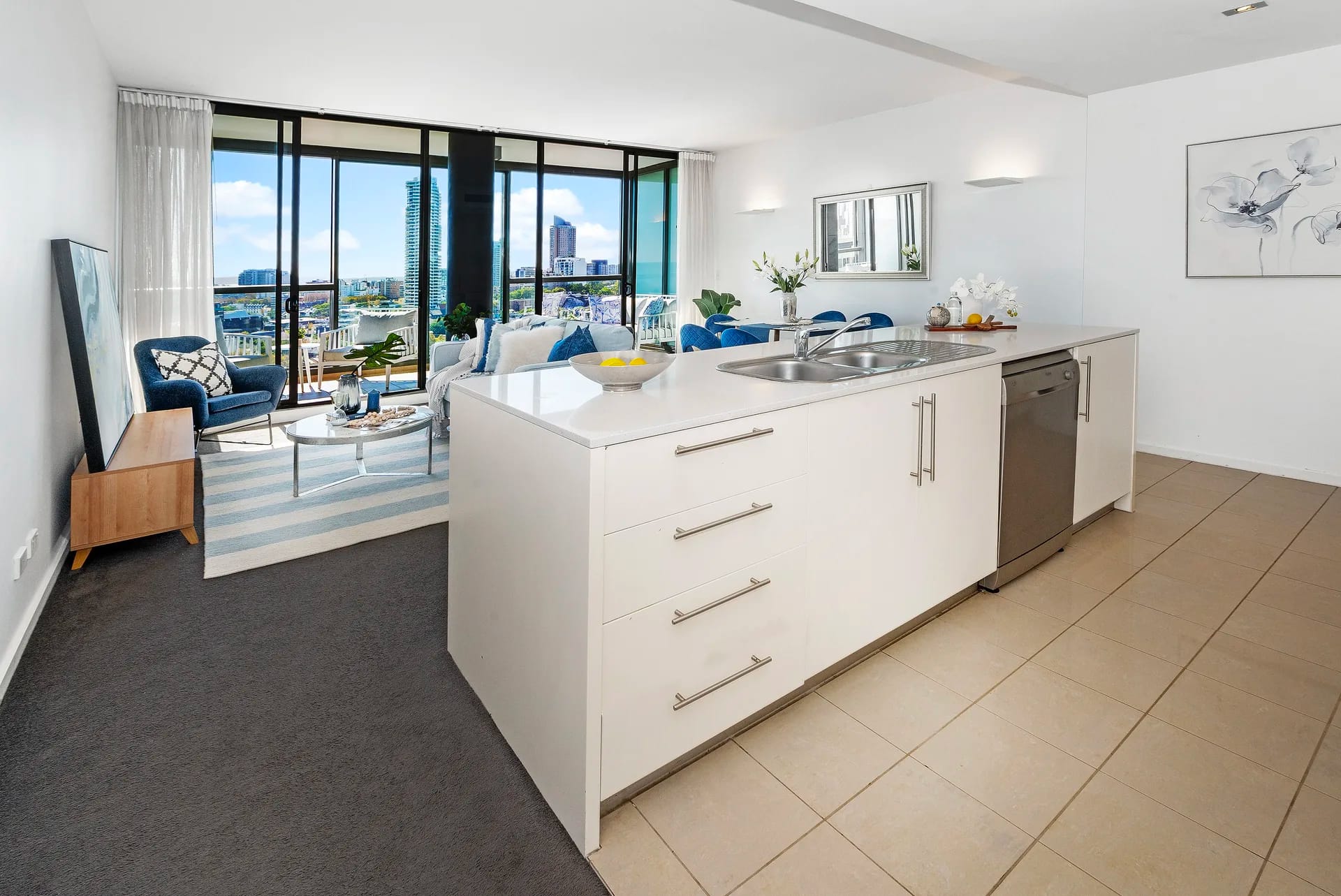 Original white laminate island with stainless sink, bar handles and beige floor tiles